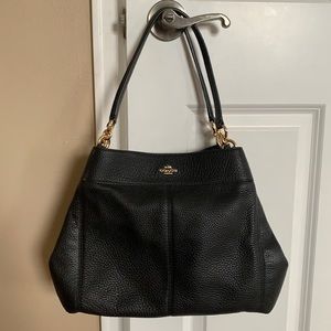 Black Coach purse with multiple pockets and divider.